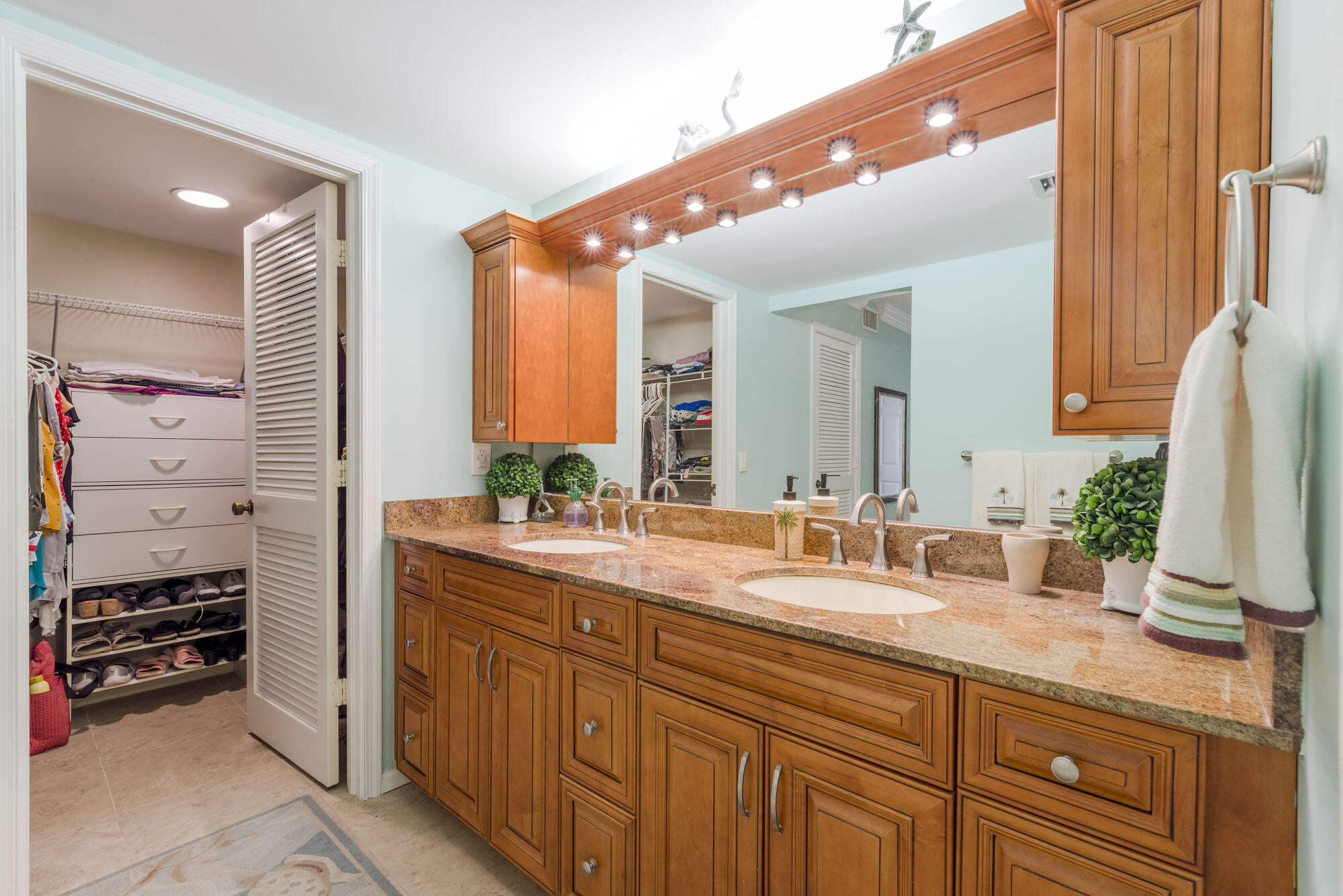 17165 Waterbend Drive, Unit 207 Jupiter, FL 33477 - Photo 23 of 27 a bathroom with a double vanity sink and a mirror