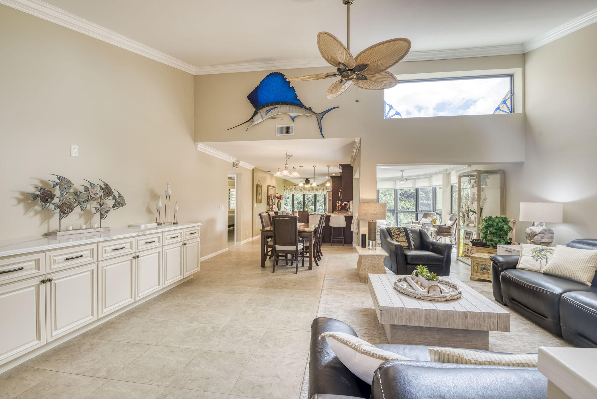 17165 Waterbend Drive, Unit 207 Jupiter, FL 33477 - Photo 4 of 27 a living room with furniture a chandelier and a large window