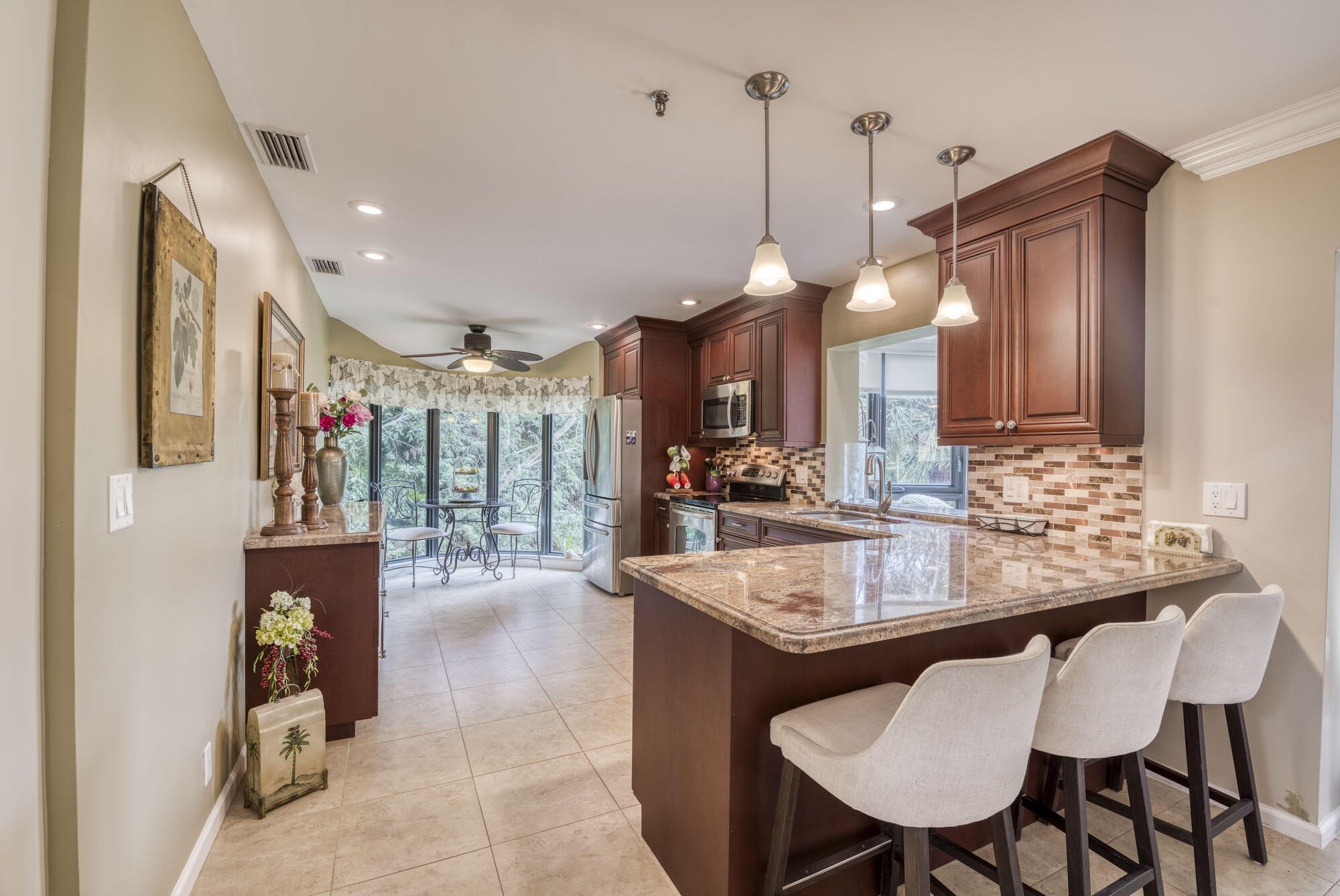 17165 Waterbend Drive, Unit 207 Jupiter, FL 33477 - Photo 9 of 27 a dining table chairs and a chandelier