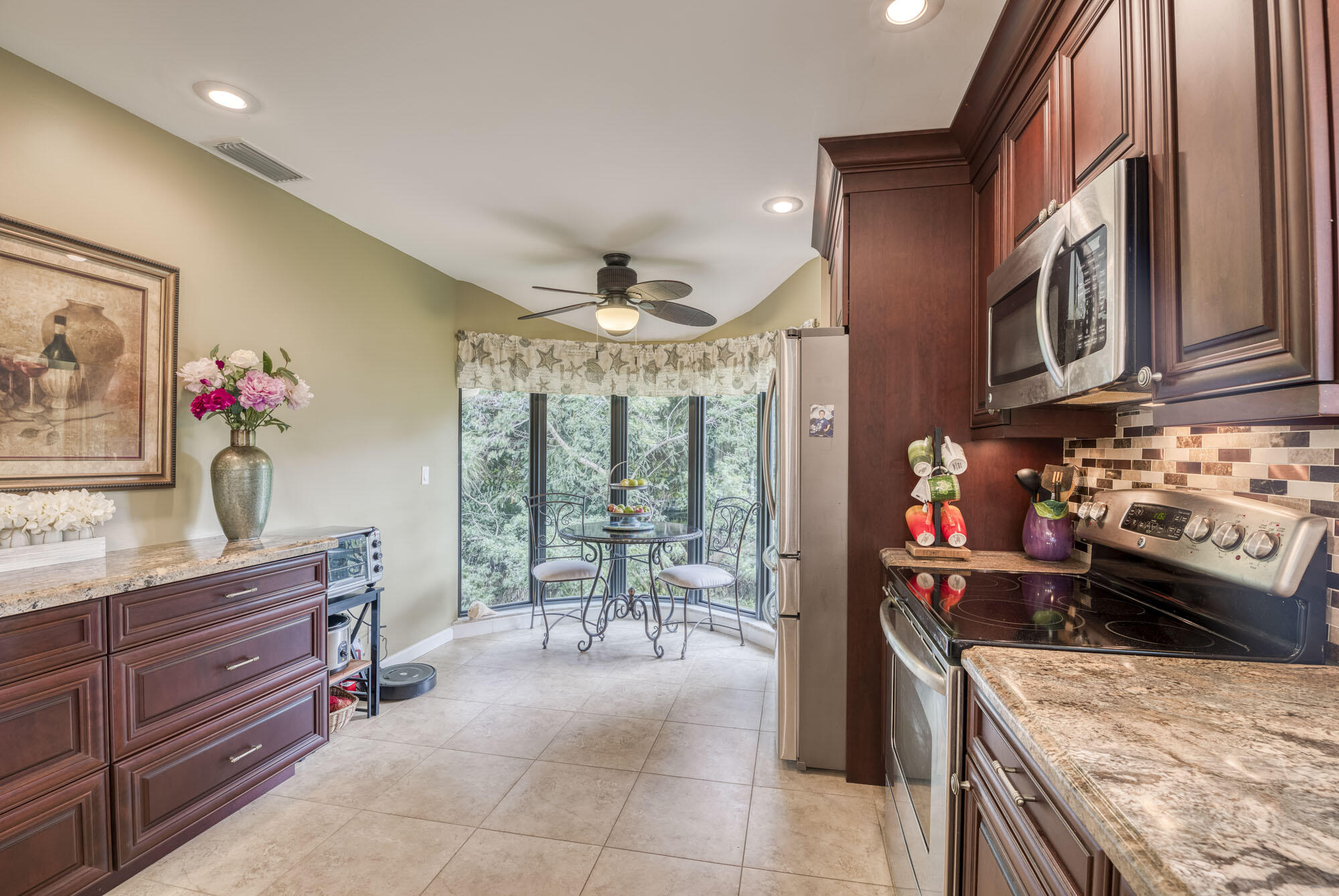 17165 Waterbend Drive, Unit 207 Jupiter, FL 33477 - Photo 10 of 27 a kitchen that has a lot of cabinets in it