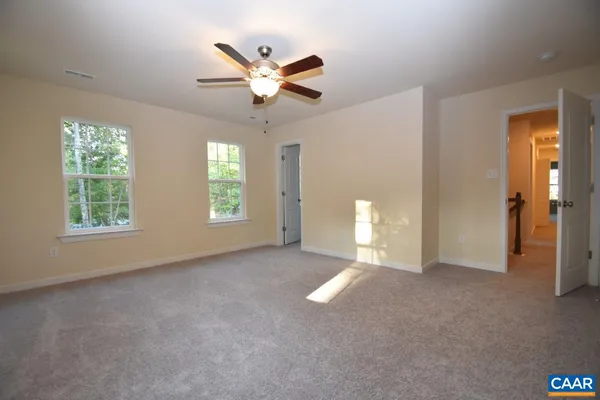 a view of a livingroom with a ceiling fan and window