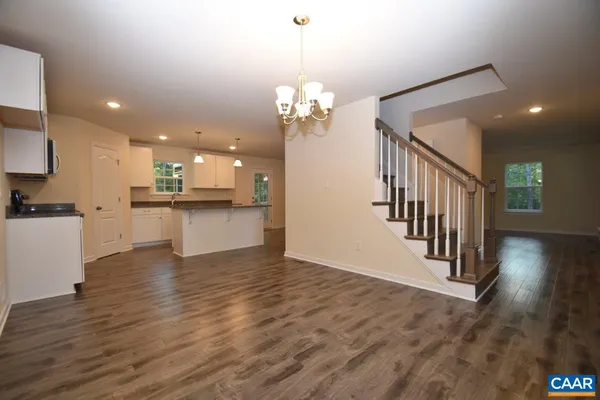 a view of a kitchen with wooden floor and a kitchen