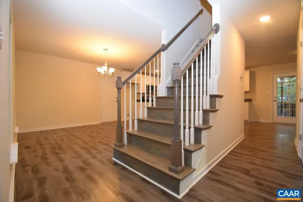 a view of entryway and hall with wooden floor