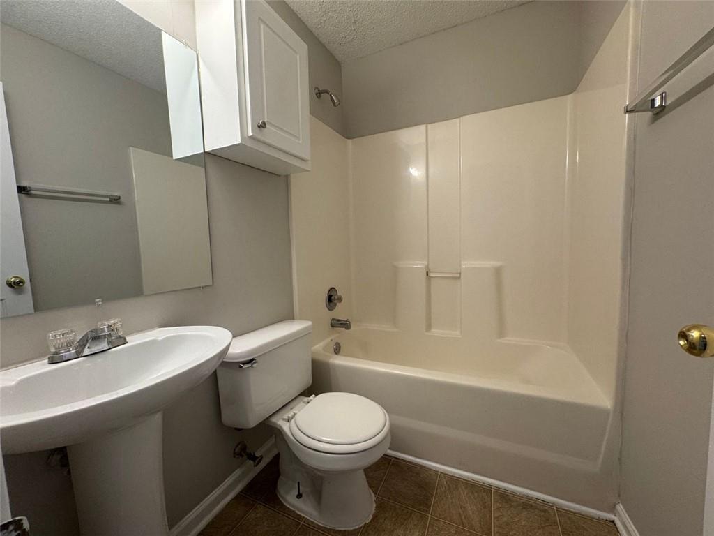 4044 Robin Circle Atlanta, GA 30349 - Photo 13 of 15 a bathroom with a sink a toilet and shower