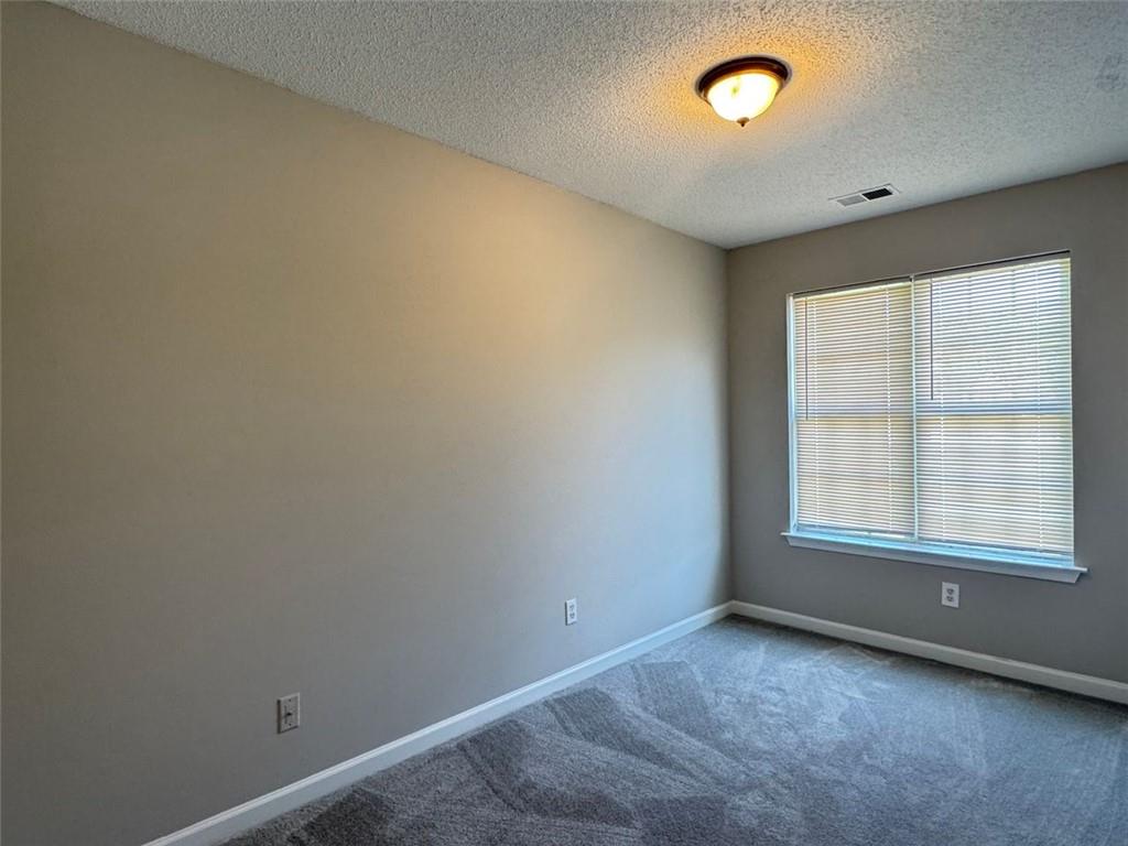 4044 Robin Circle Atlanta, GA 30349 - Photo 3 of 15 an empty room with a empty space and windows