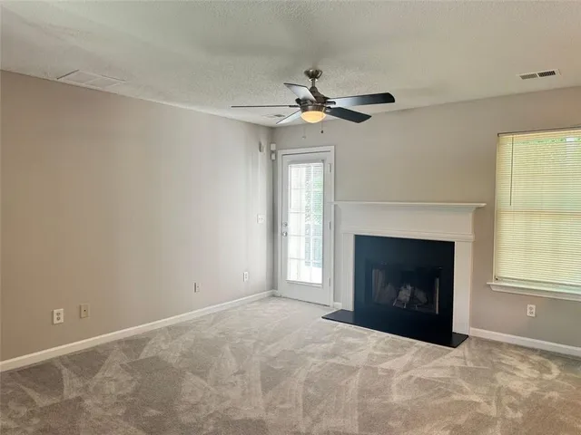 a view of empty room with a fireplace