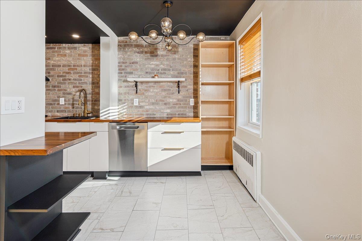 2 Bronxville Road, Unit 8D Bronxville, NY 10708 - Photo 6 of 23 a room with granite countertop a sink and a stove top oven