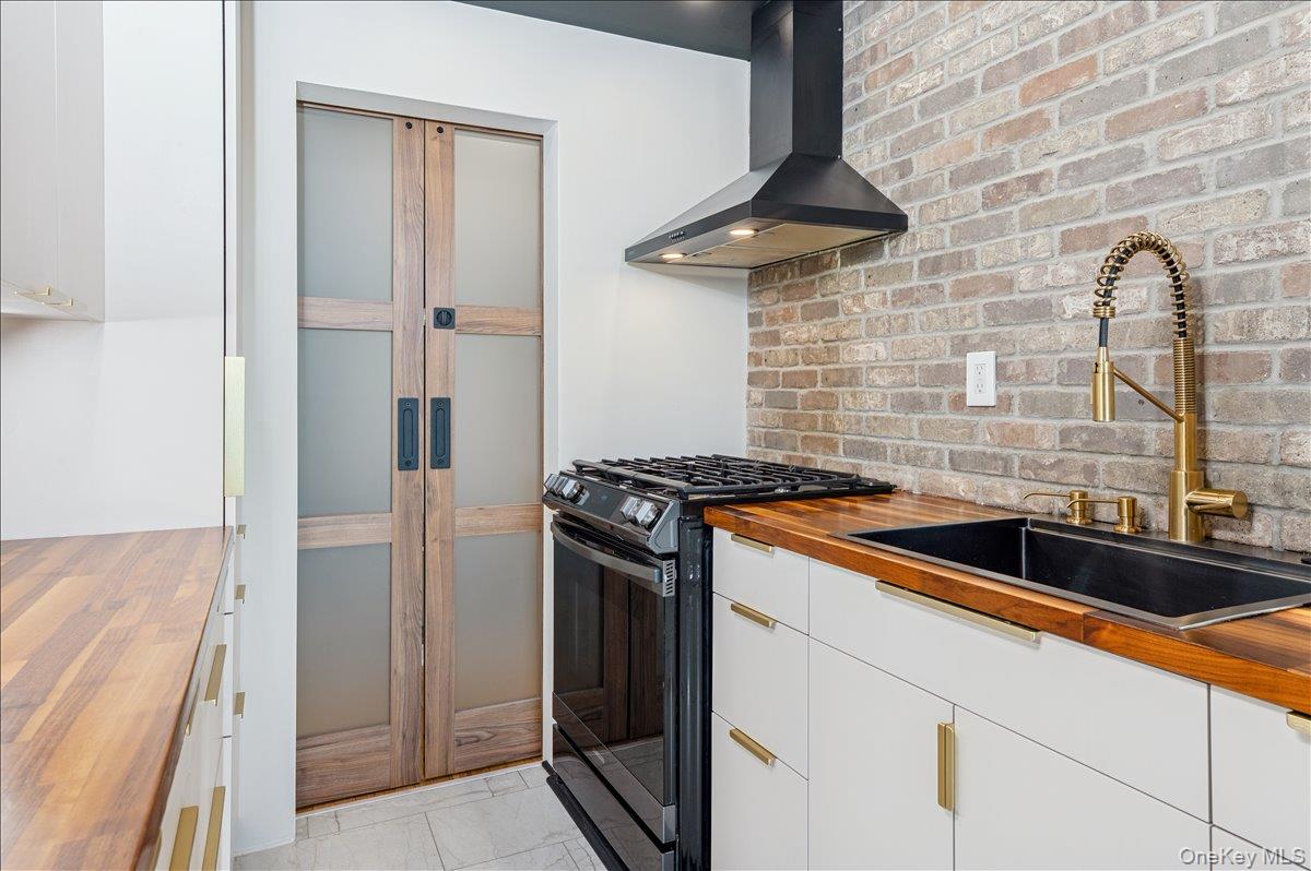 2 Bronxville Road, Unit 8D Bronxville, NY 10708 - Photo 8 of 23 a kitchen with stainless steel appliances granite countertop a sink a stove and refrigerator