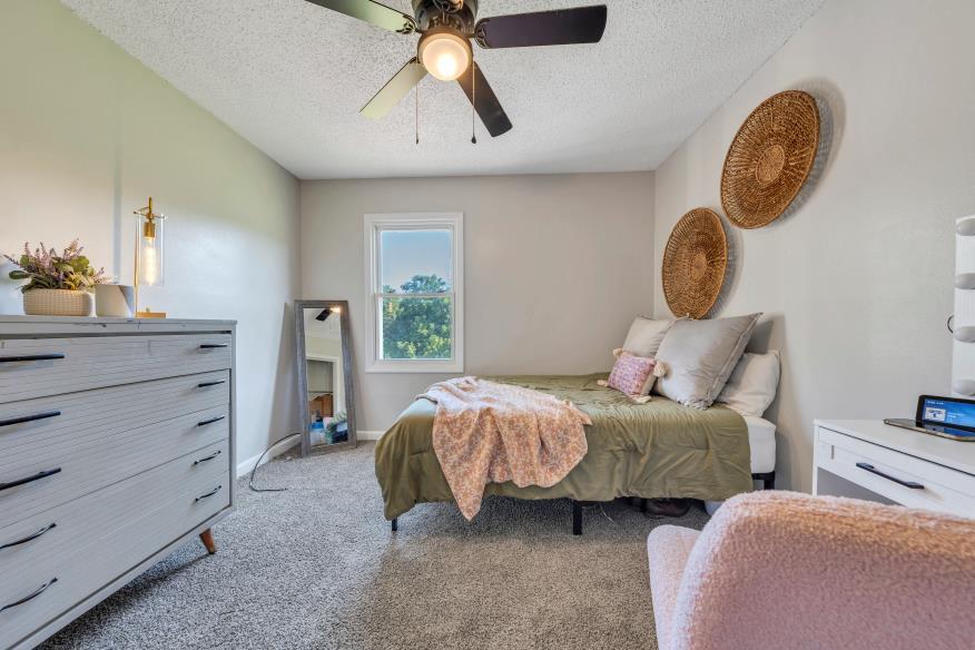 6400 Stewartsville Road Moneta, VA 24121 - Photo 12 of 33 a bedroom with bed and a chandelier