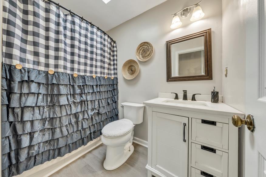 6400 Stewartsville Road Moneta, VA 24121 - Photo 13 of 33 a bathroom with a sink toilet and shower