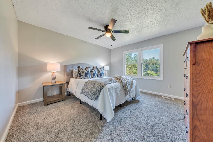 6400 Stewartsville Road Moneta, VA 24121 - Photo 14 of 33 a spacious bedroom with a bed and a window