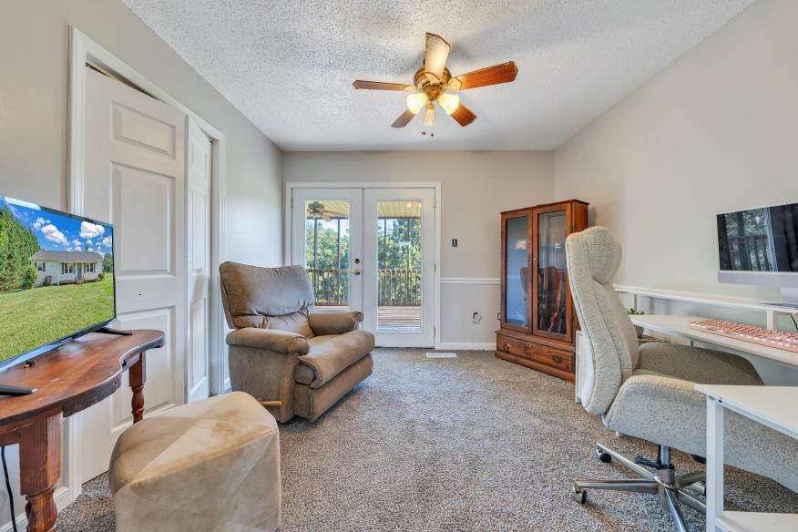 6400 Stewartsville Road Moneta, VA 24121 - Photo 17 of 33 a living room with furniture and a flat screen tv