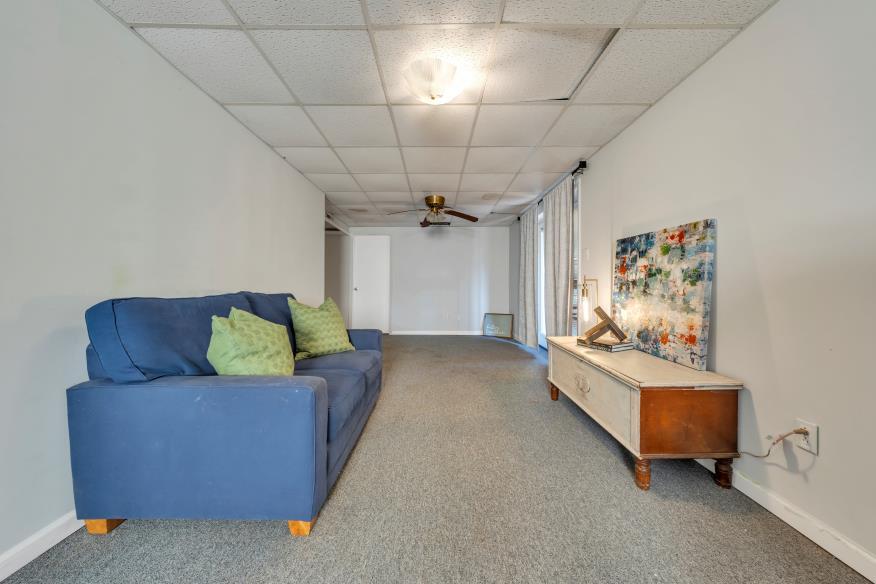 6400 Stewartsville Road Moneta, VA 24121 - Photo 19 of 33 a living room with furniture and a chandelier