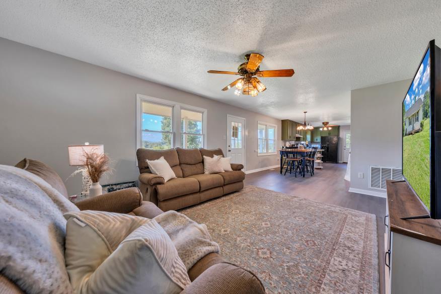 6400 Stewartsville Road Moneta, VA 24121 - Photo 4 of 33 a living room with furniture and a flat screen tv