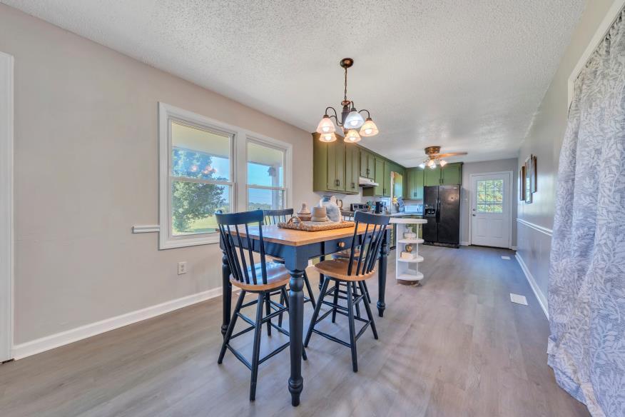 6400 Stewartsville Road Moneta, VA 24121 - Photo 7 of 33 a view of a dining room with furniture window and wooden floor