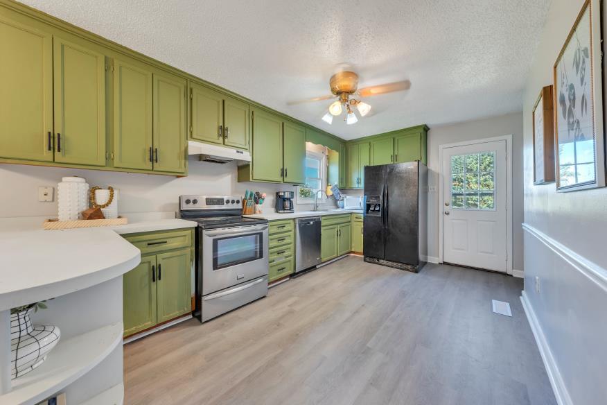 6400 Stewartsville Road Moneta, VA 24121 - Photo 8 of 33 a kitchen with a refrigerator sink and cabinets