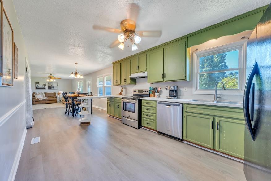 6400 Stewartsville Road Moneta, VA 24121 - Photo 9 of 33 a kitchen with sink cabinets and wooden floor