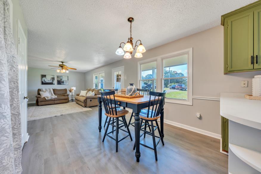 6400 Stewartsville Road Moneta, VA 24121 - Photo 10 of 33 a view of a a dining room with furniture window and wooden floor