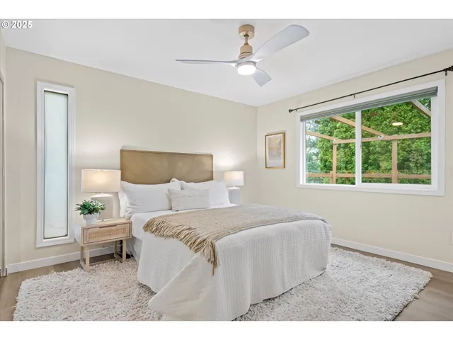 a bedroom with a bed and a painting on the wall