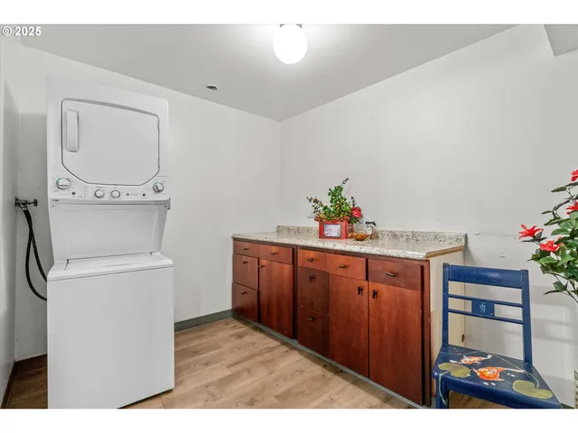 a view of backyard with large trees and wooden fence