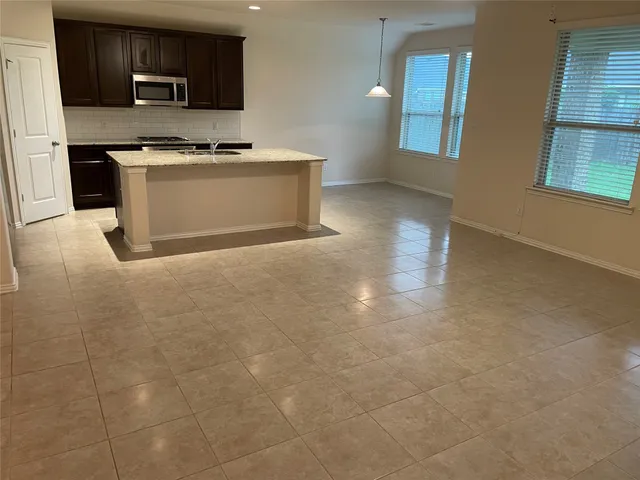 a kitchen with stainless steel appliances a refrigerator and a stove top oven