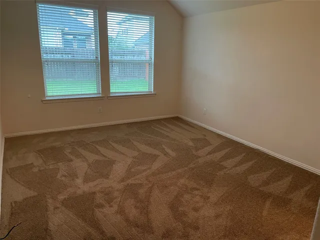 a view of empty room with a bathroom