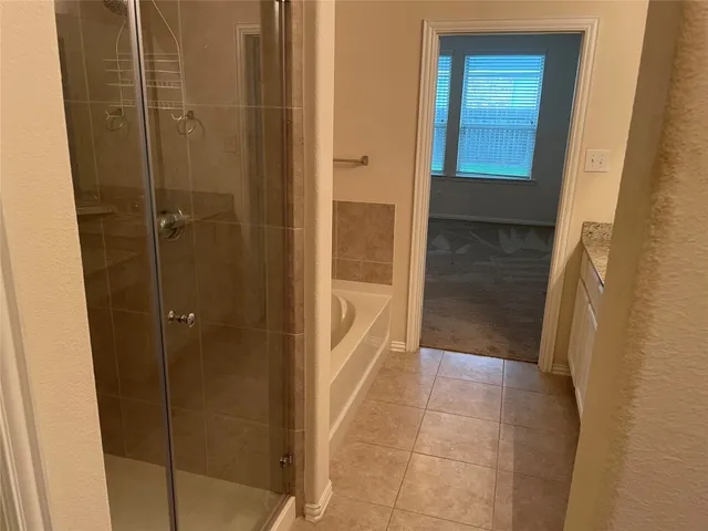 a bathroom with a granite countertop sink and a toilet