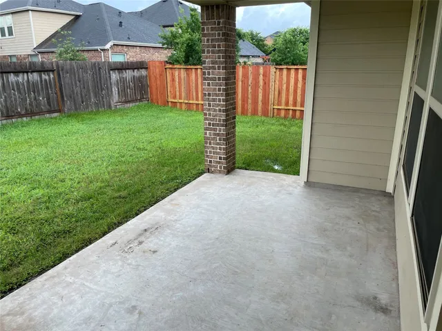 a view of a backyard with wooden fence