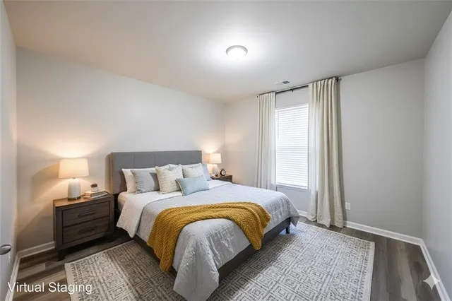 a bedroom with a bed and a night stand