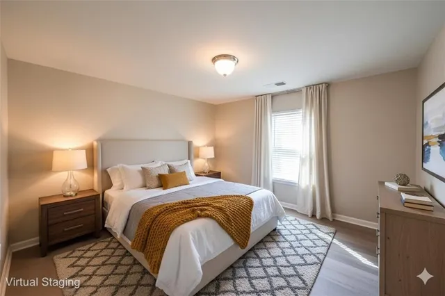 a bedroom with a bed and a lamp with the dresser