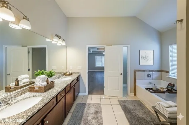 a spacious bathroom with a granite countertop sink and a mirror