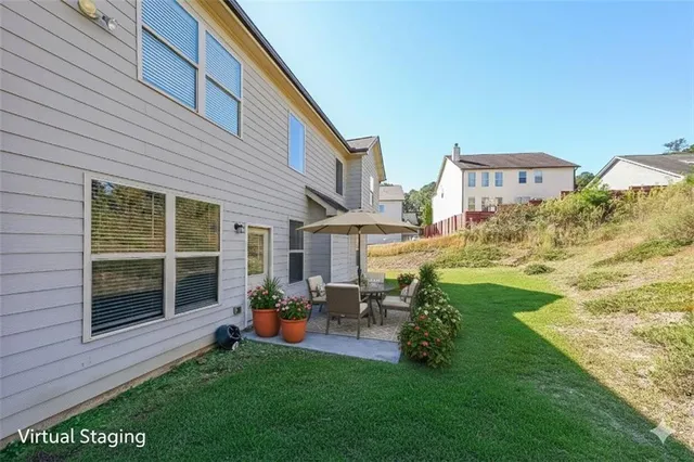 a group of people sitting in front of a house