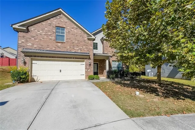 a front view of a house with a yard