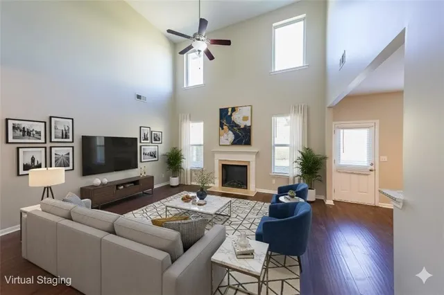a living room with furniture a flat screen tv and a fireplace