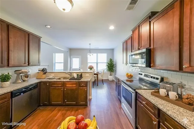 a large kitchen with a large window and stainless steel appliances