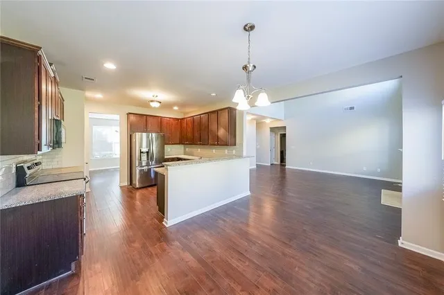 a view of a kitchen with a sink stainless steel appliances and cabinets