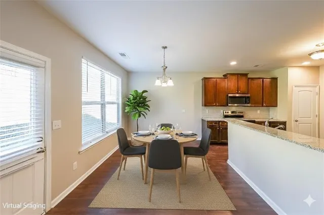 a view of a dining room with furniture window and wooden floor