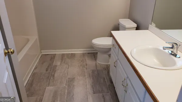 a bathroom with a sink a toilet and a vanity