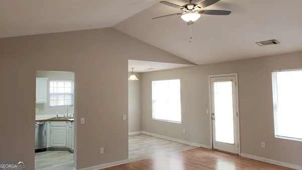 a view of a kitchen with a sink and a window