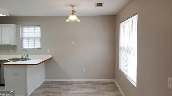 a kitchen with a refrigerator sink and cabinets