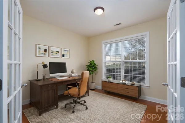 a kitchen with kitchen island stainless steel appliances a sink a stove a refrigerator and cabinets