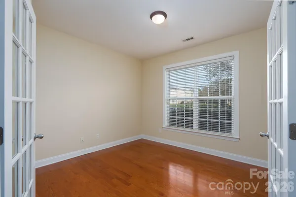 a kitchen with stainless steel appliances granite countertop a refrigerator a stove and a sink with wooden floor