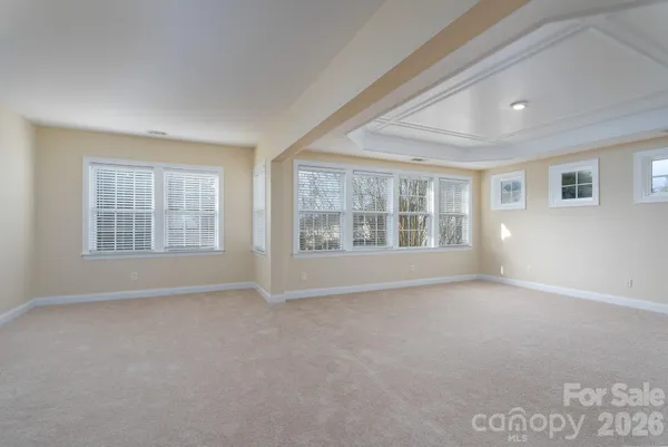a spacious bathroom with a toilet sink and mirror
