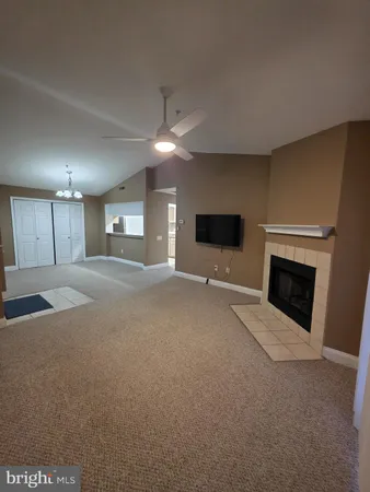 a view of a livingroom with an empty space and a fireplace