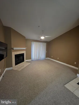 a view of empty room with a fireplace