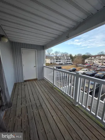 a view of balcony with wooden floor