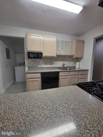 a kitchen with a stove a sink and a refrigerator
