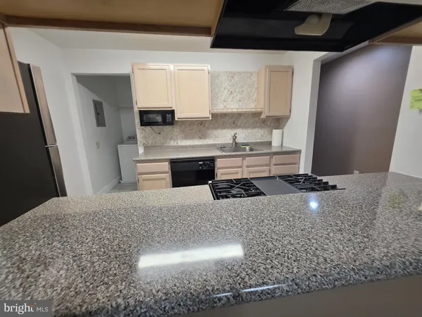 a kitchen with a sink a stove and cabinets