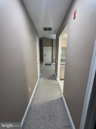 hallway with wooden floor and stairs