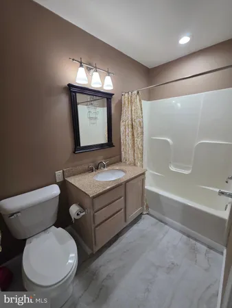 a bathroom with a sink toilet mirror and bathtub